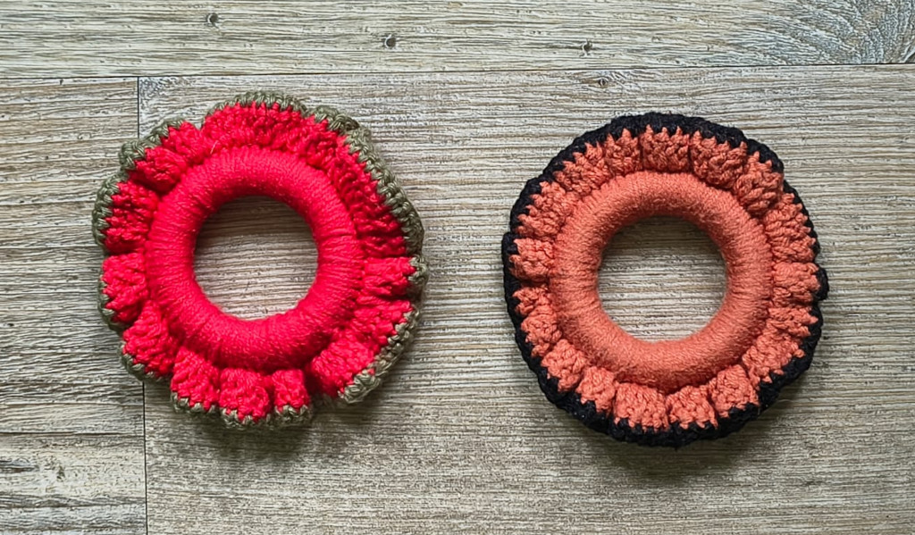 Christmas napkin ring in red and green alongside Halloween napkin ring in orange and black