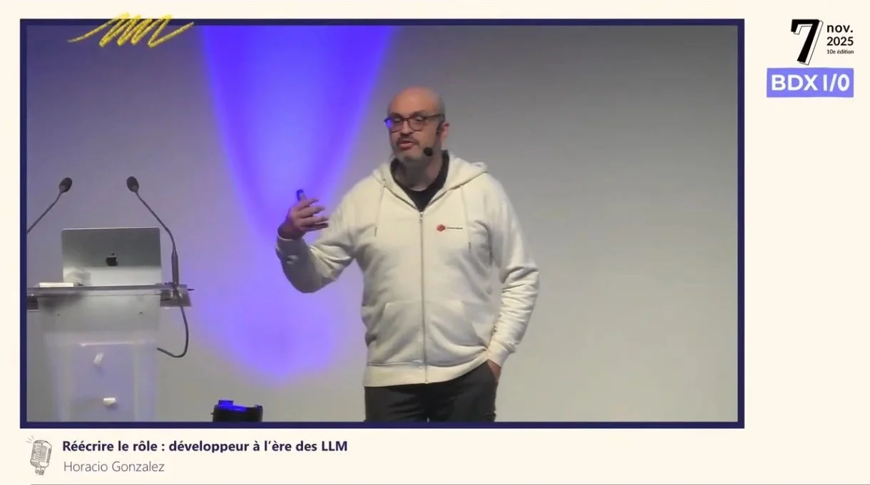 Horacio on stage at BDX I/O on 7 November 2025, in a white hoodie, during his talk "Rewriting the role: developers in the age of LLMs"